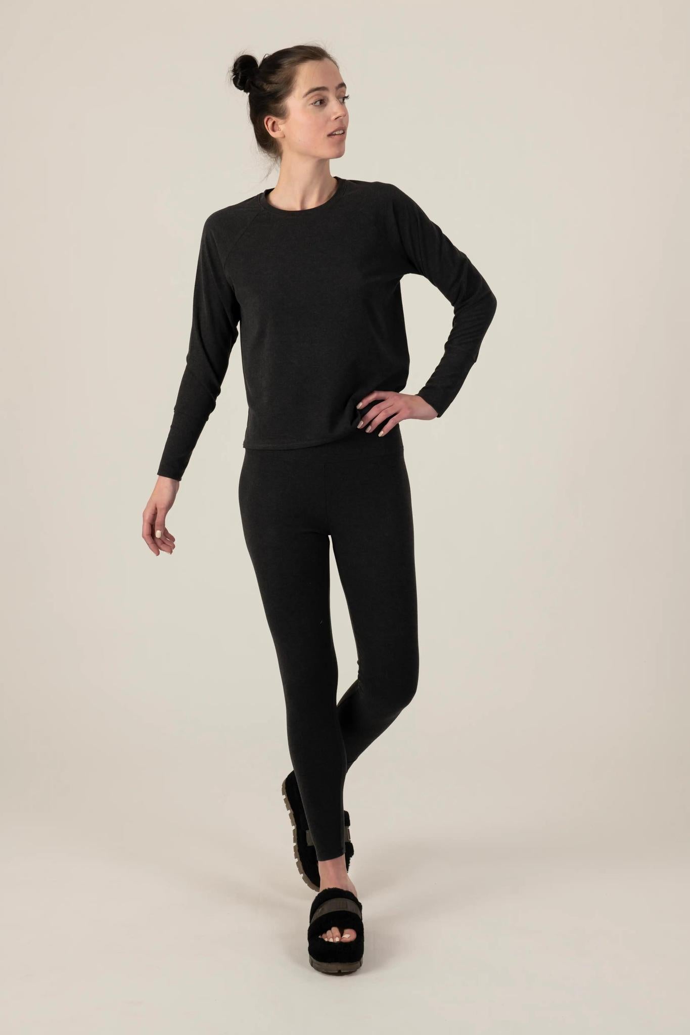 Model wearing Comfy Leggings in Graphite with mid-rise fit and soft stretch fabric.