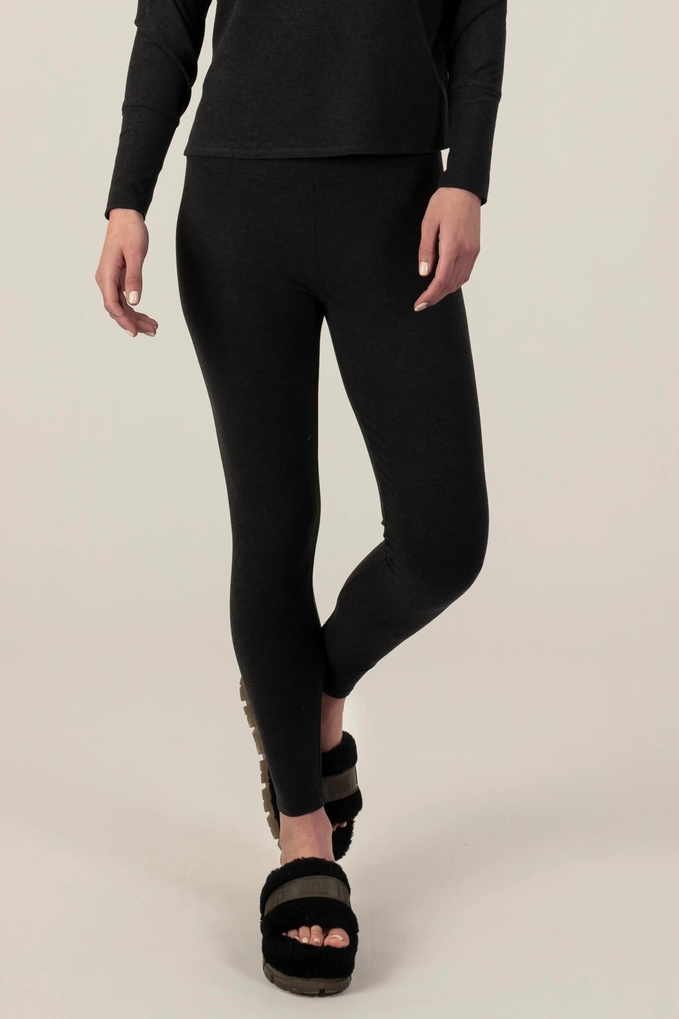 Model wearing Comfy Leggings in Graphite with mid-rise fit and soft stretch fabric.