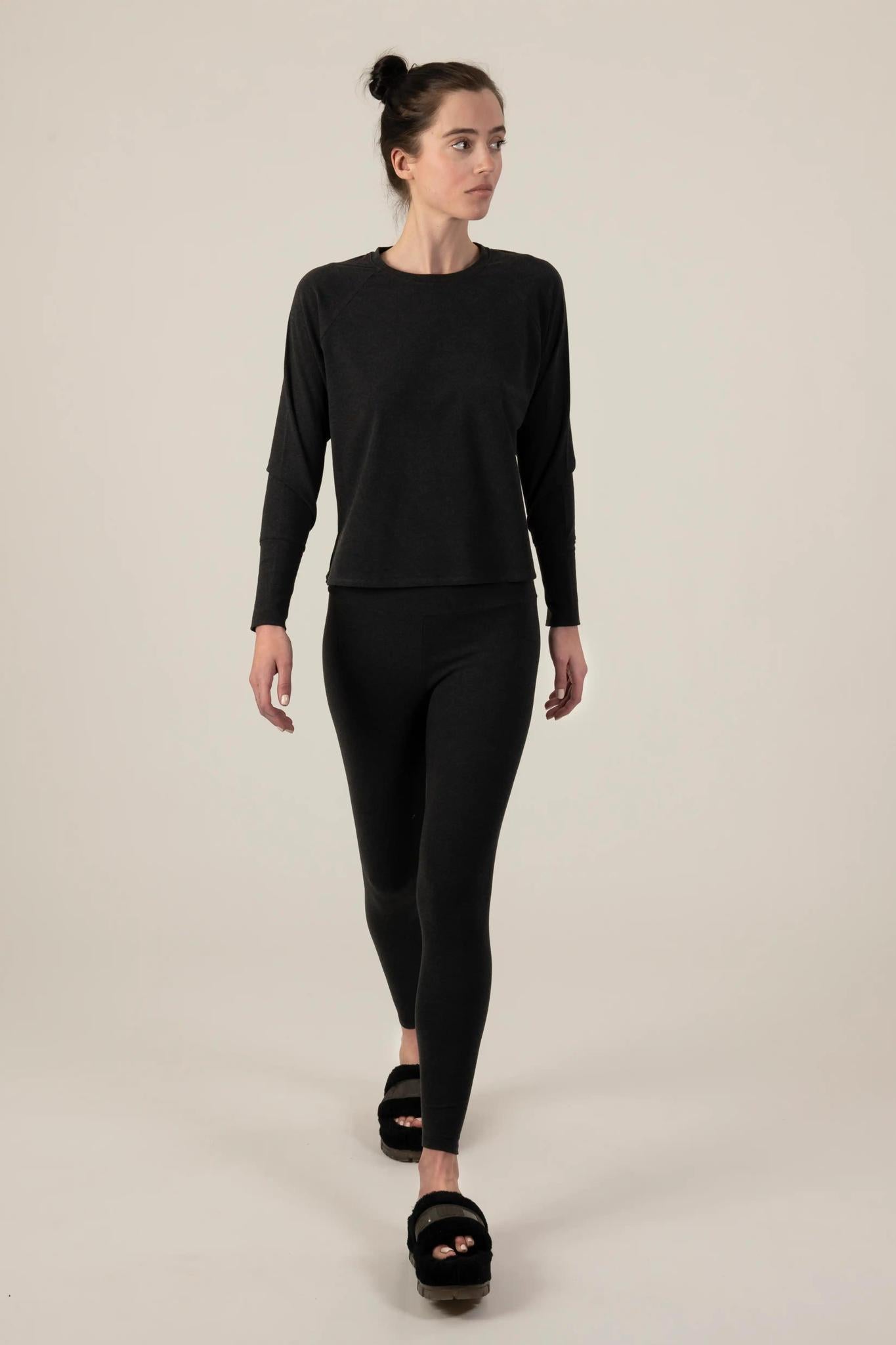 Model wearing Comfy Leggings in Graphite with mid-rise fit and soft stretch fabric.