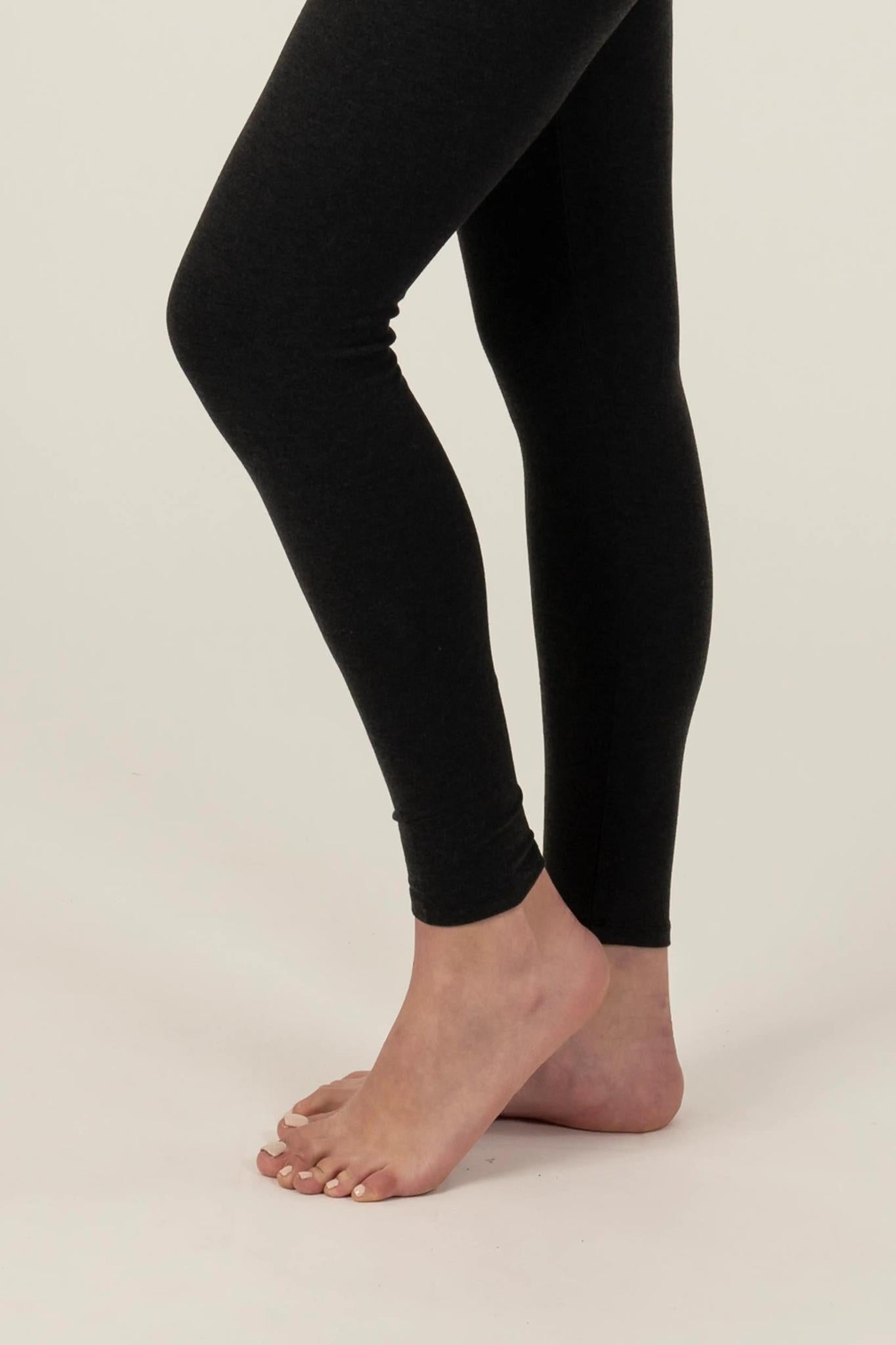Model wearing Comfy Leggings in Graphite with mid-rise fit and soft stretch fabric.