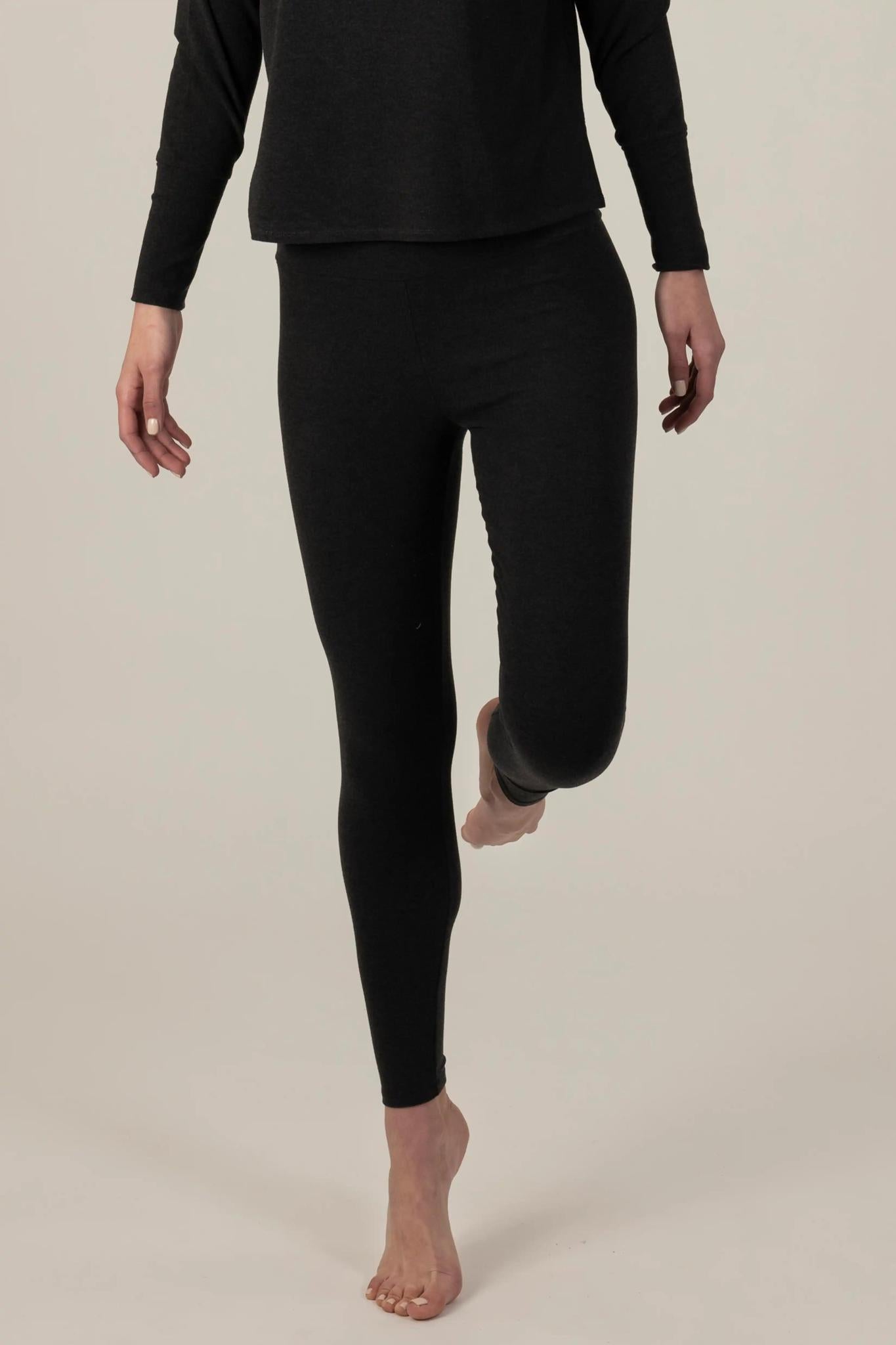 Model wearing Comfy Leggings in Graphite with mid-rise fit and soft stretch fabric.