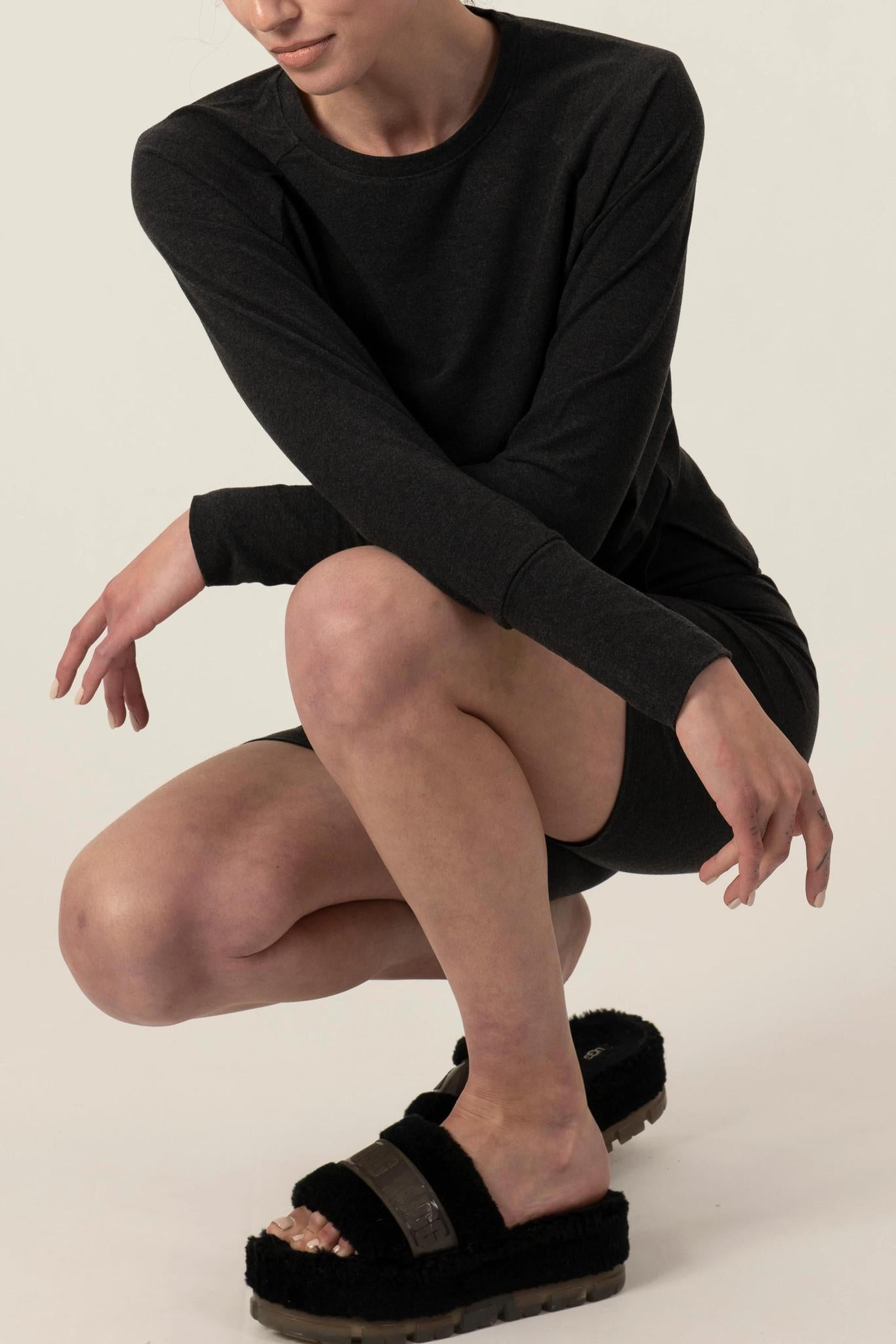 Model wearing graphite relaxed-fit cozy top with round neckline and dropped shoulders with matching shorts
