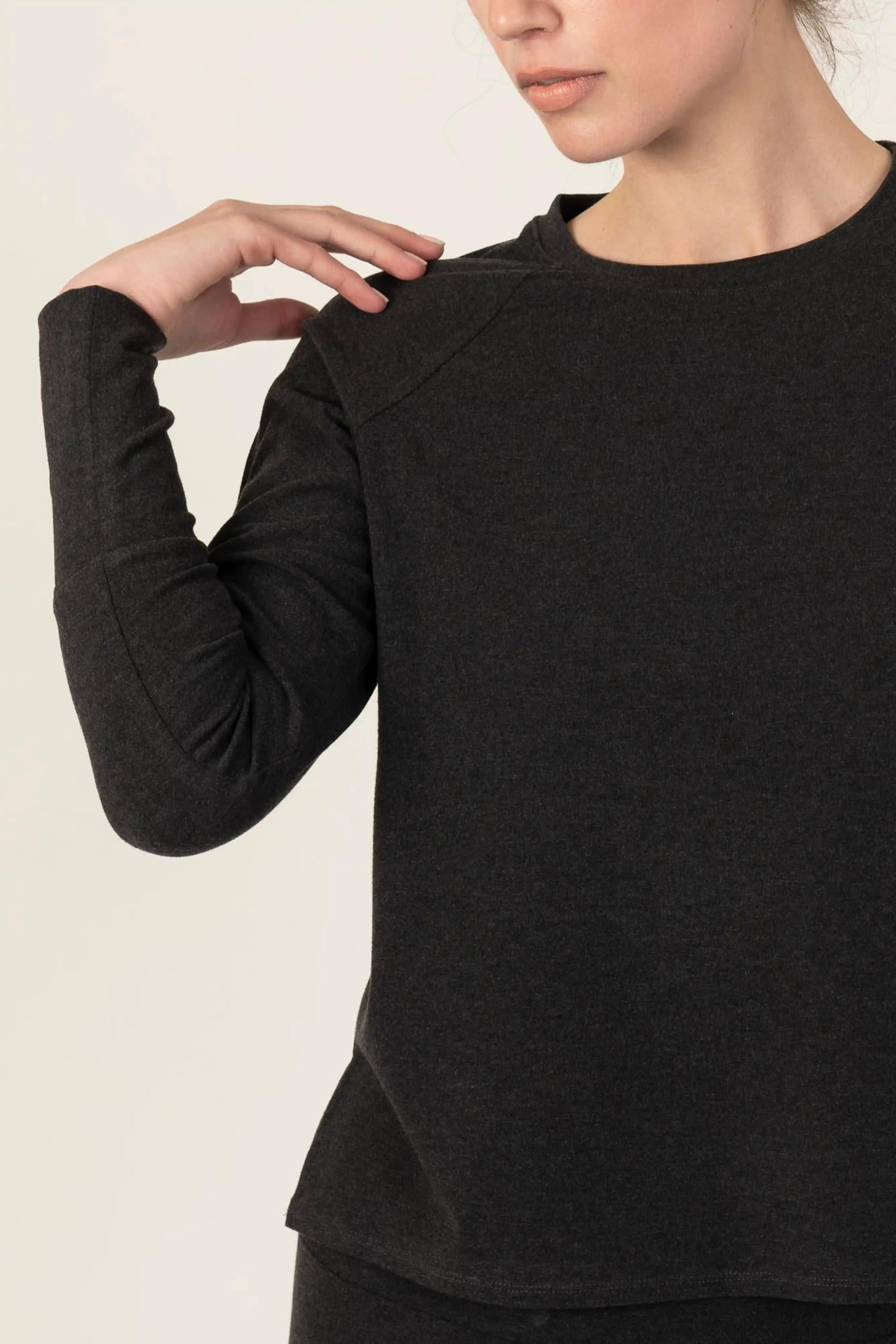 Model wearing graphite relaxed-fit cozy top with round neckline and dropped shoulders