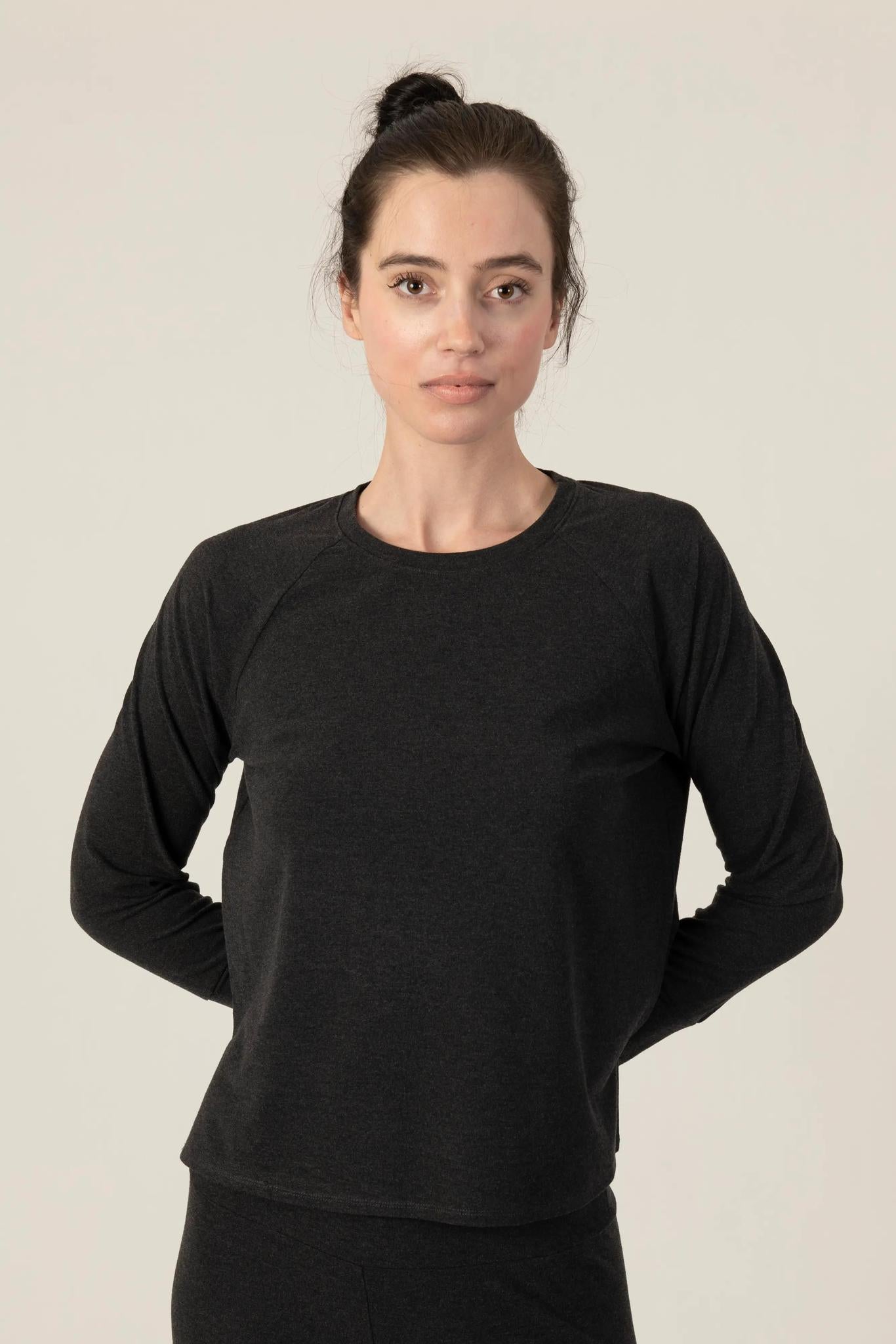 Model wearing graphite relaxed-fit cozy top with round neckline and dropped shoulders