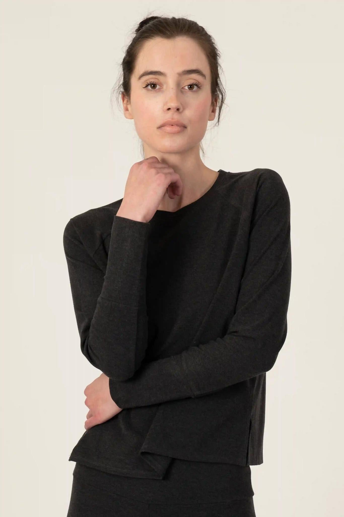 Model wearing graphite relaxed-fit cozy top with round neckline and dropped shoulders