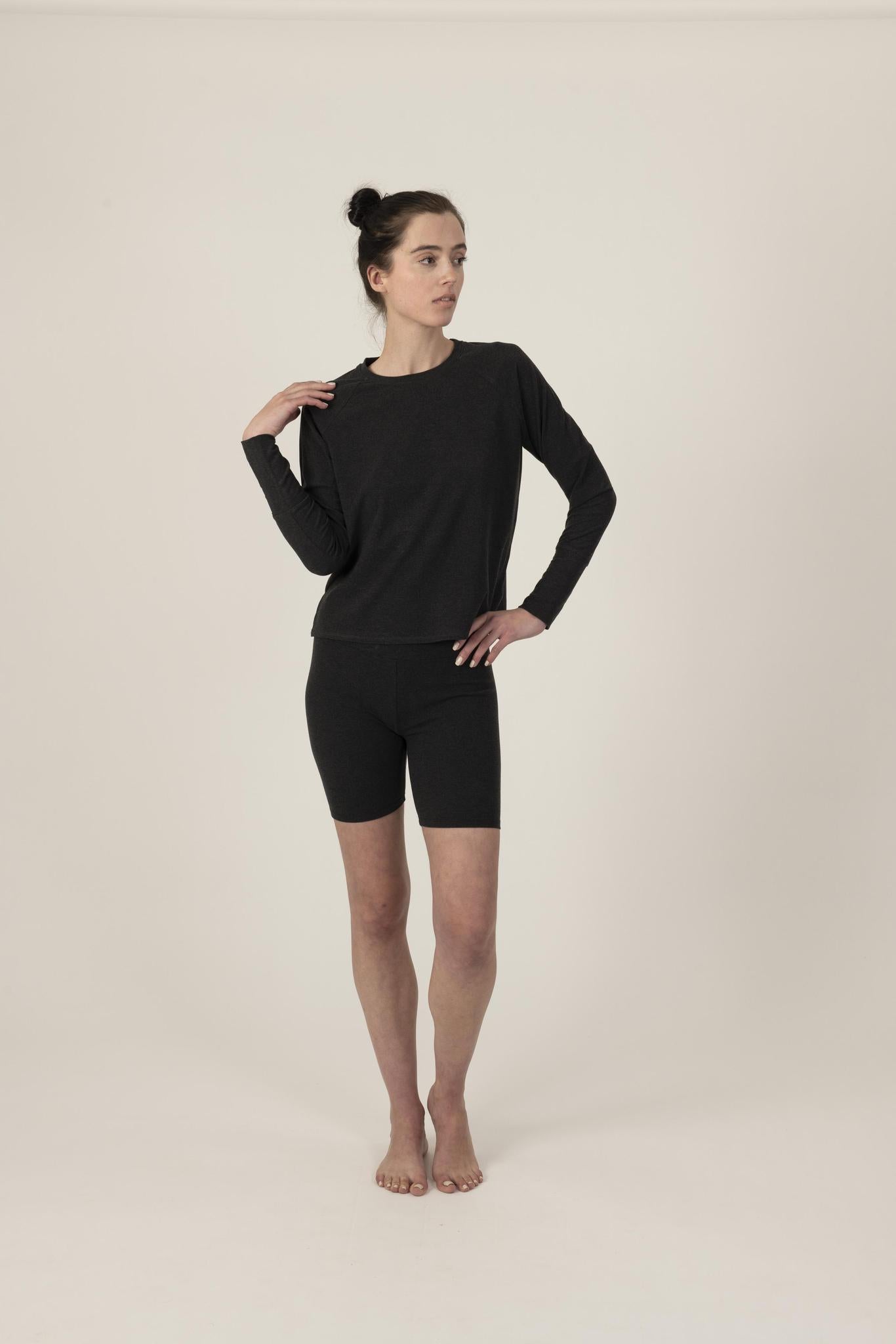 Model wearing graphite relaxed-fit cozy top with round neckline and dropped shoulders