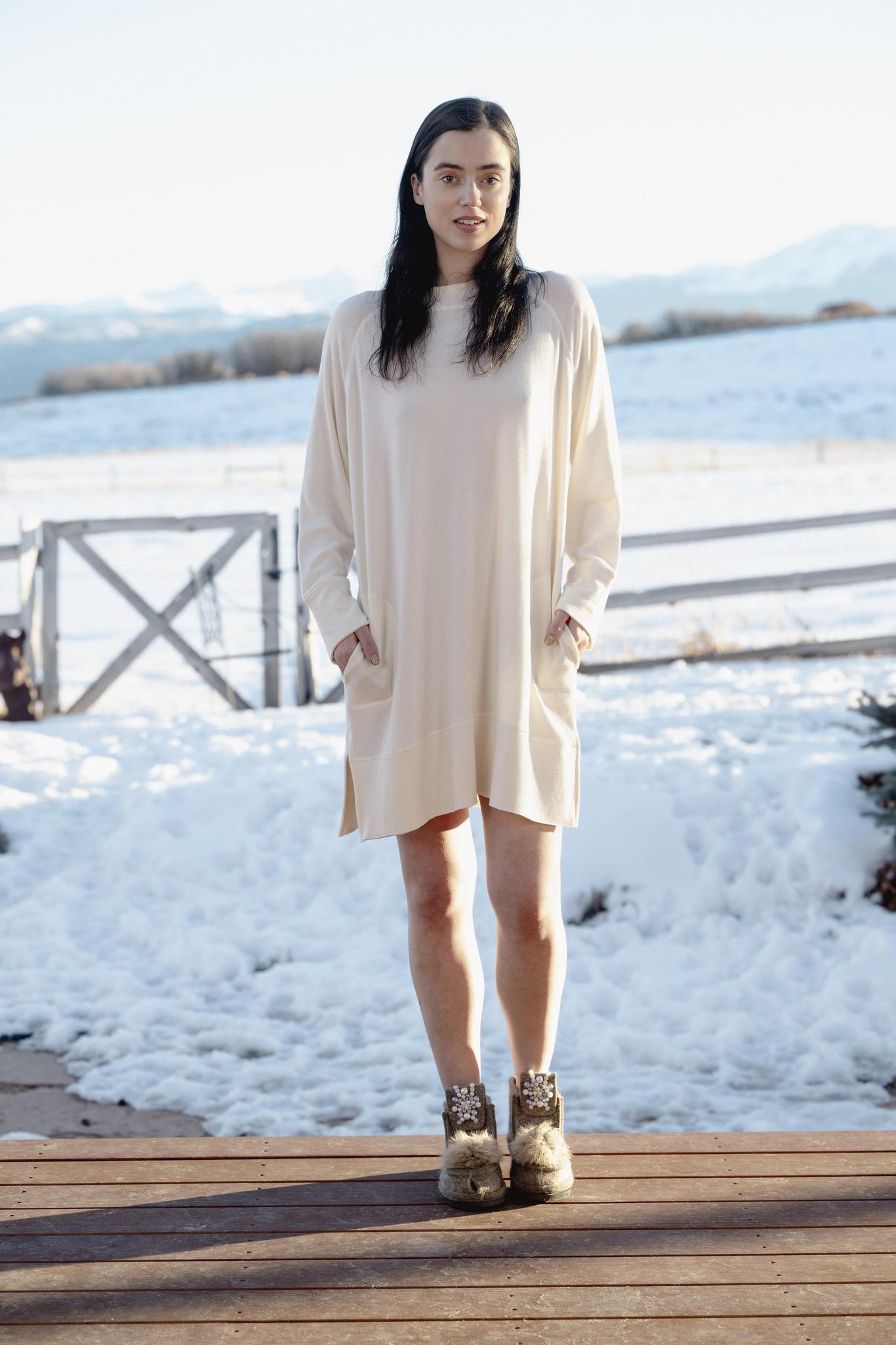 Model wearing Cozy Dress in Cashmere with relaxed fit, round neckline, and side pockets.
