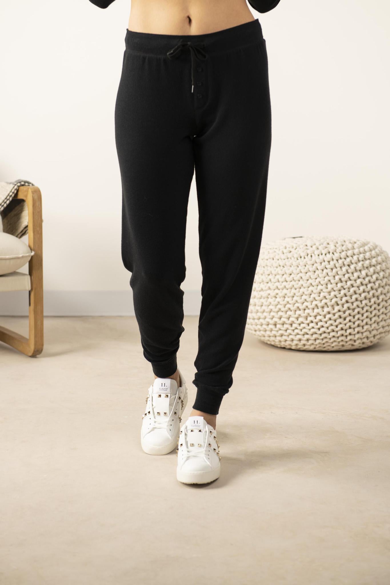 Model wearing Cozy Long Pajama Joggers in black with elastic waistband.