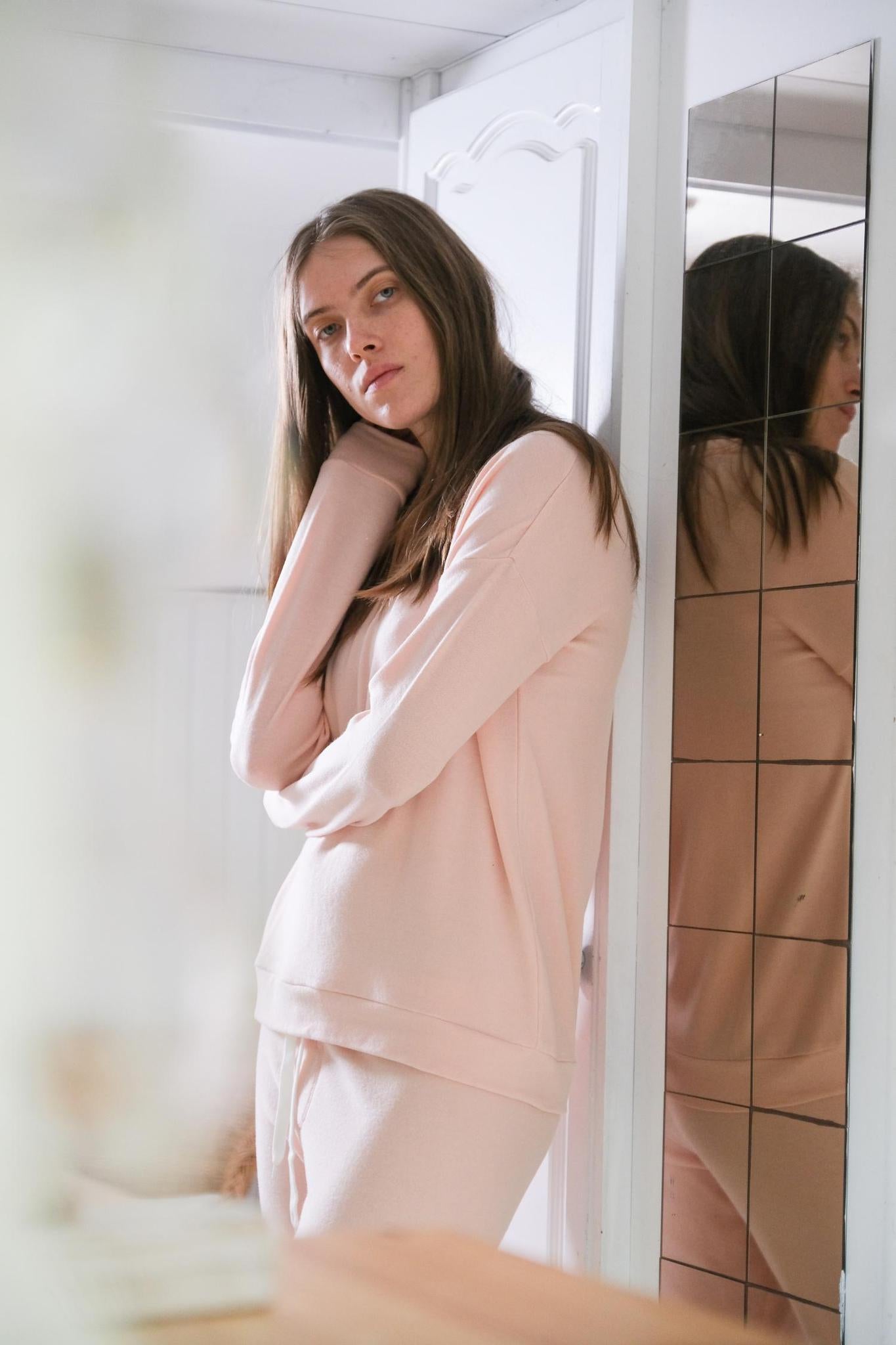 Model wearing Cozy Long Pajama Set in peach with joggers and a long-sleeve top.