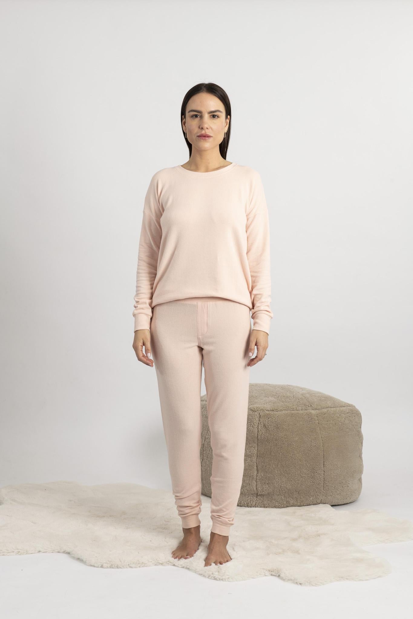 Model wearing Cozy Long Pajama Set in peach with joggers and a long-sleeve top.