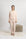 Model wearing Cozy Long Pajama Set in peach with joggers and a long-sleeve top.