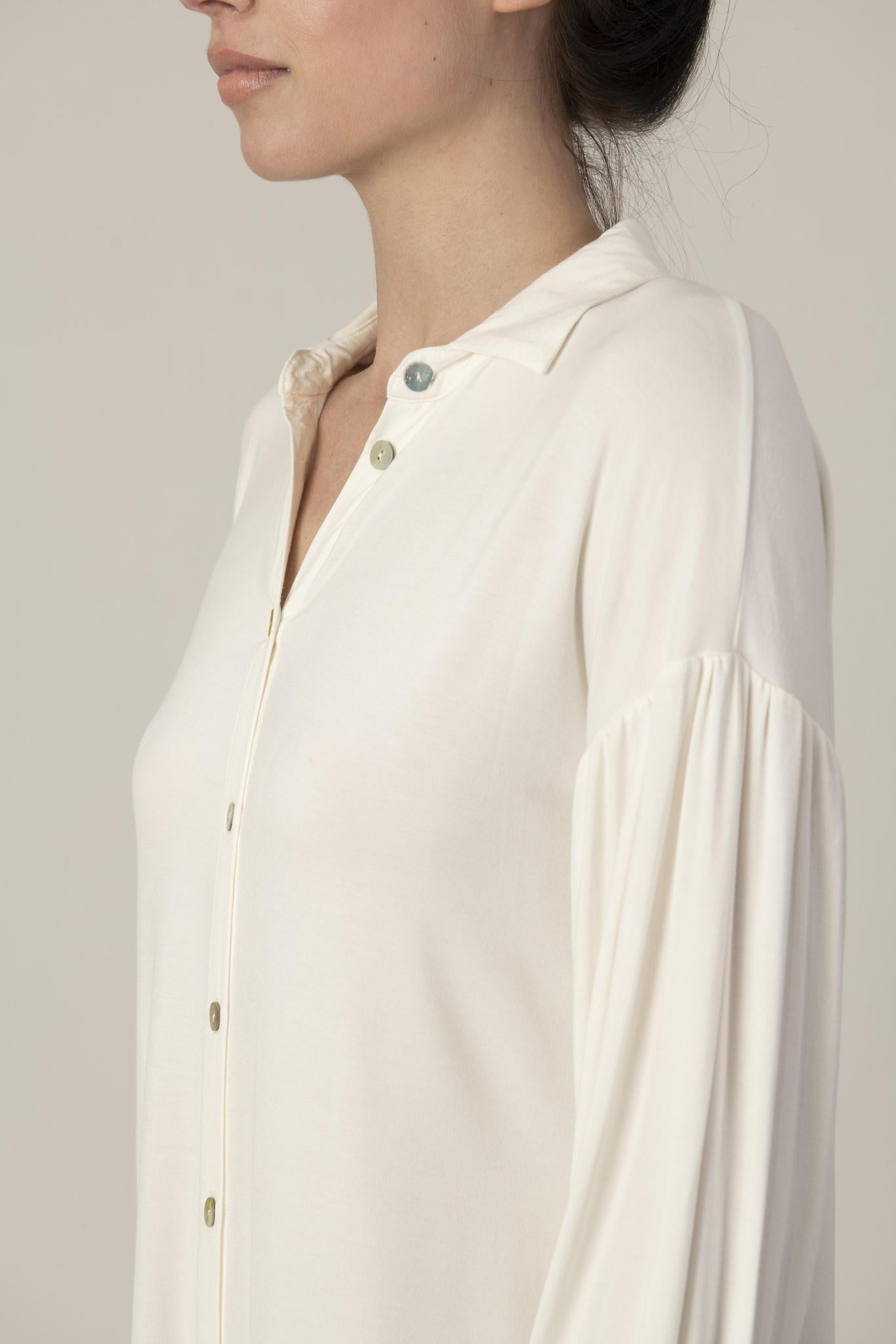Close-up of gathered sleeve detail and mother-of-pearl buttons on the ivory Dahlia nightshirt