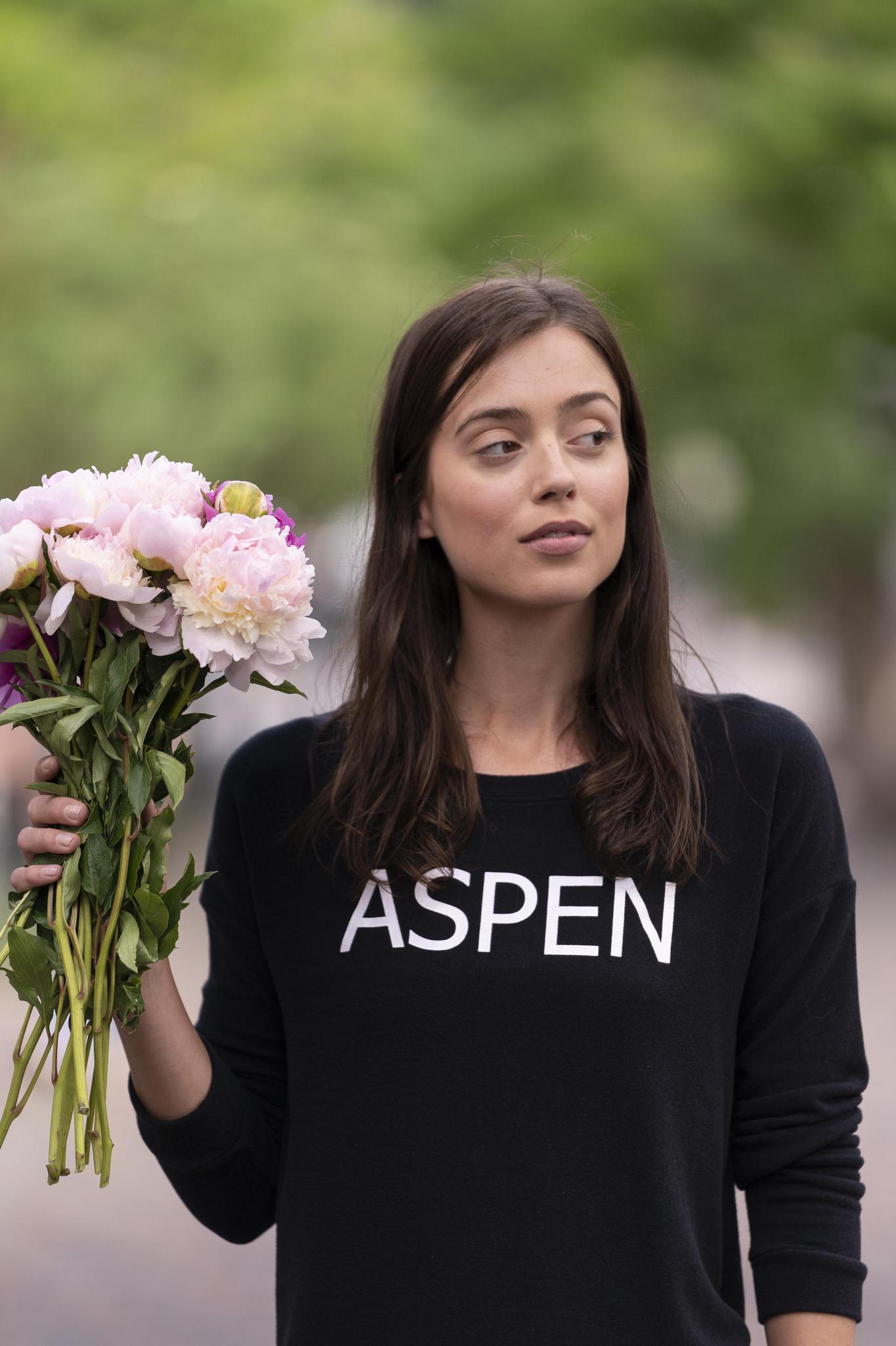 Model wearing black Hello from Aspen long sleeve top with relaxed fit and crew neckline