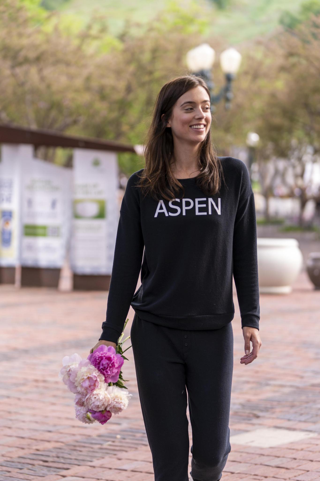 Model wearing black Hello from Aspen long sleeve top with relaxed fit and crew neckline