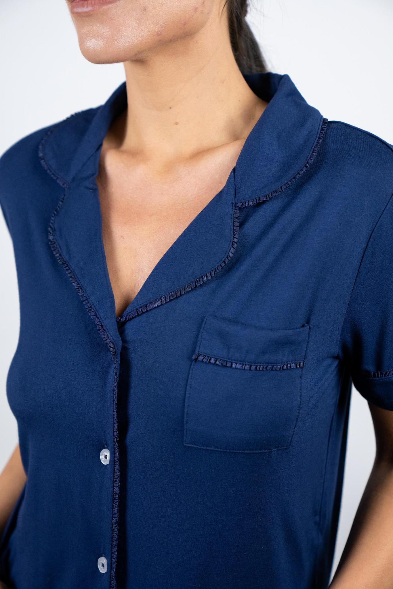 Close-up of ivory buttons and Japanese ruffled piping on the navy Jolene pajama top with notch collar