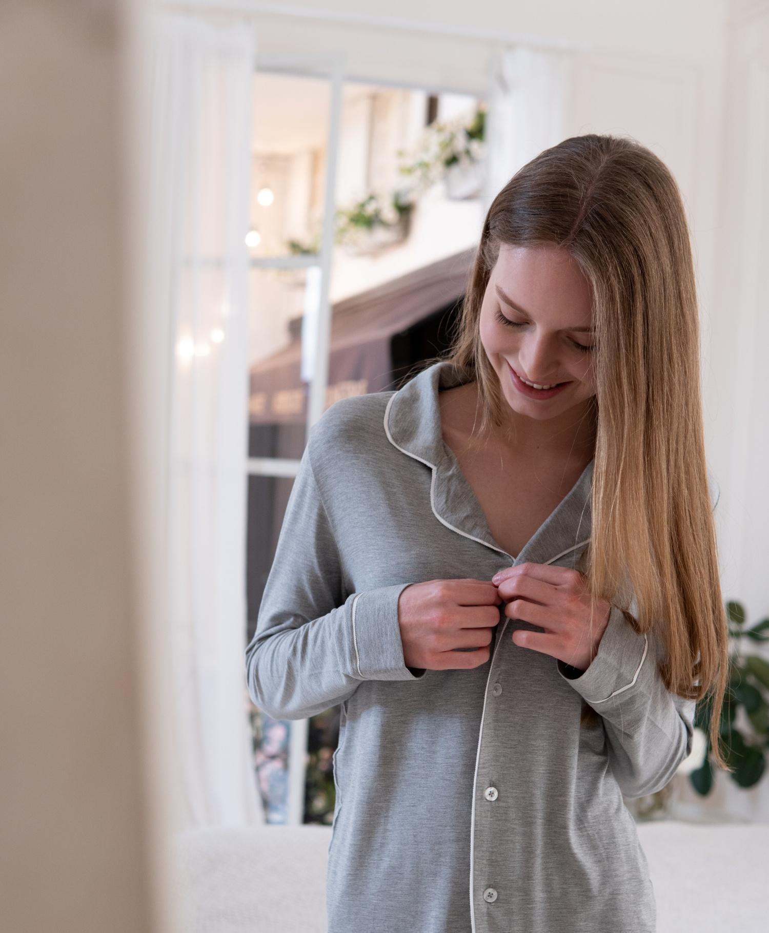 Model wearing Jolene Long Pajama Top in heather gray with white piping and white buttons