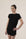 Model wearing Black lounge short set with rolled sleeve top and drawstring shorts