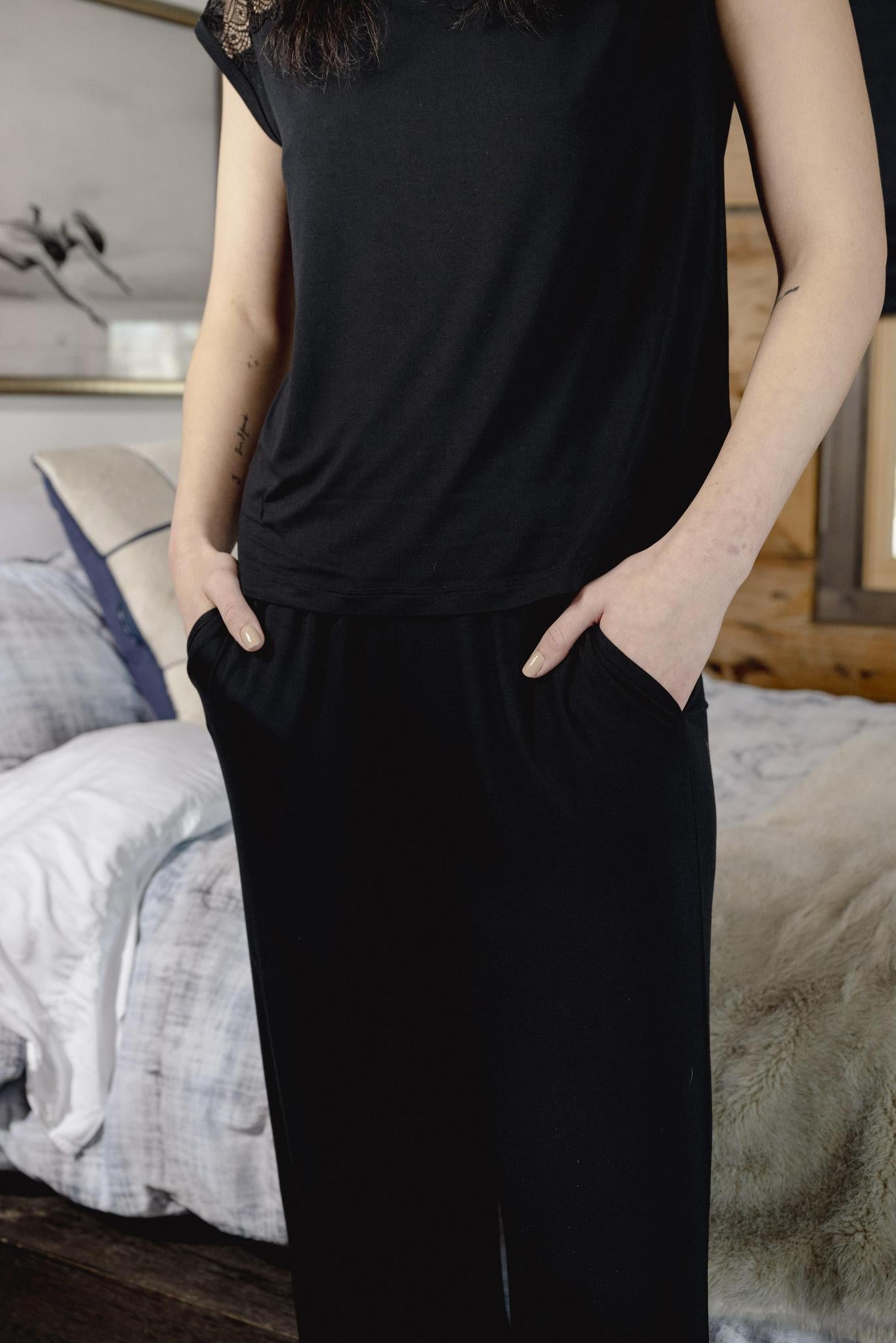 Model wearing Nora T-Shirt and Pants Set in black with lace panel detail and wide-leg bamboo pants.