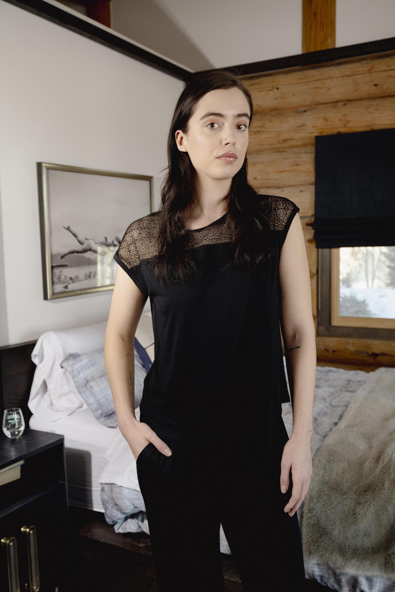 Model wearing Nora T-Shirt and Pants Set in black with lace panel detail and wide-leg bamboo pants.