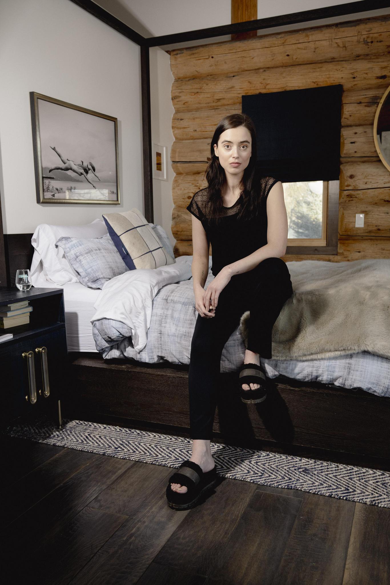 Model wearing Nora T-Shirt and Pants Set in black with lace panel detail and wide-leg bamboo pants.