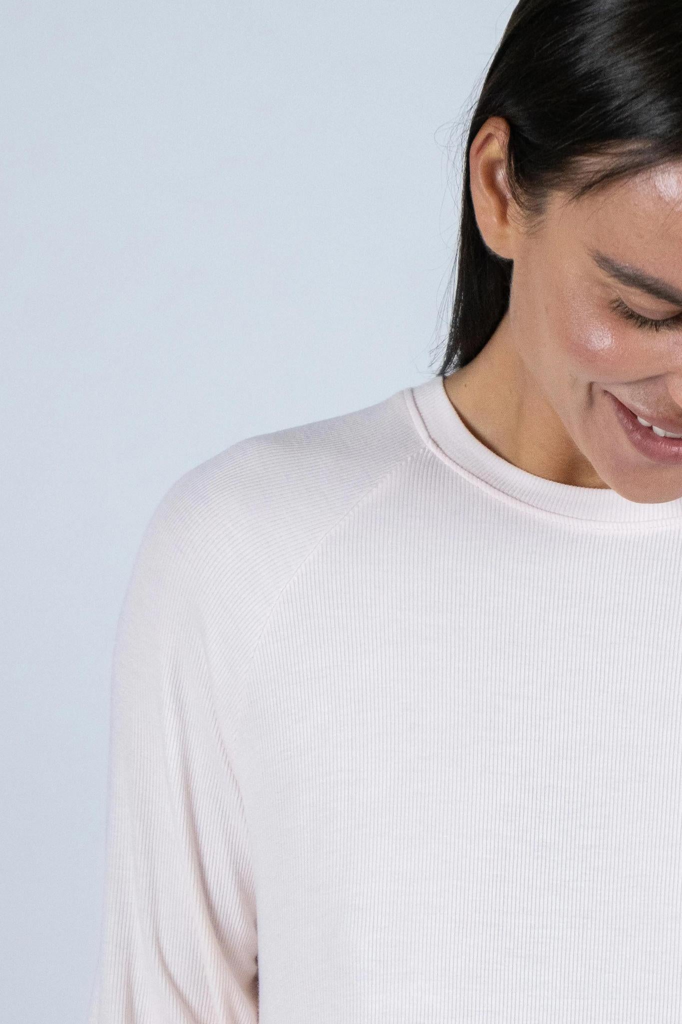 Close-up of ribbed bamboo fabric and stitching on rosewater long sleeve top