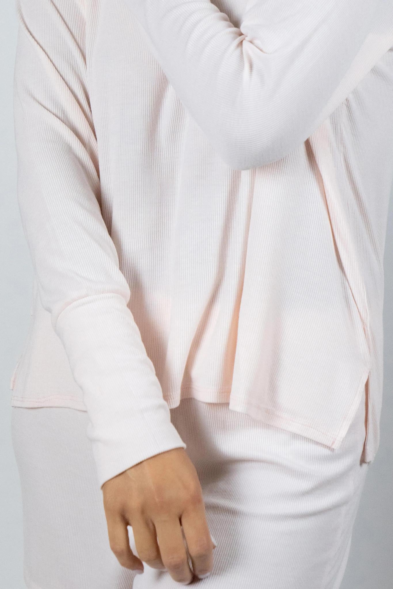 Close-up of ribbed bamboo fabric and stitching on rosewater long sleeve top