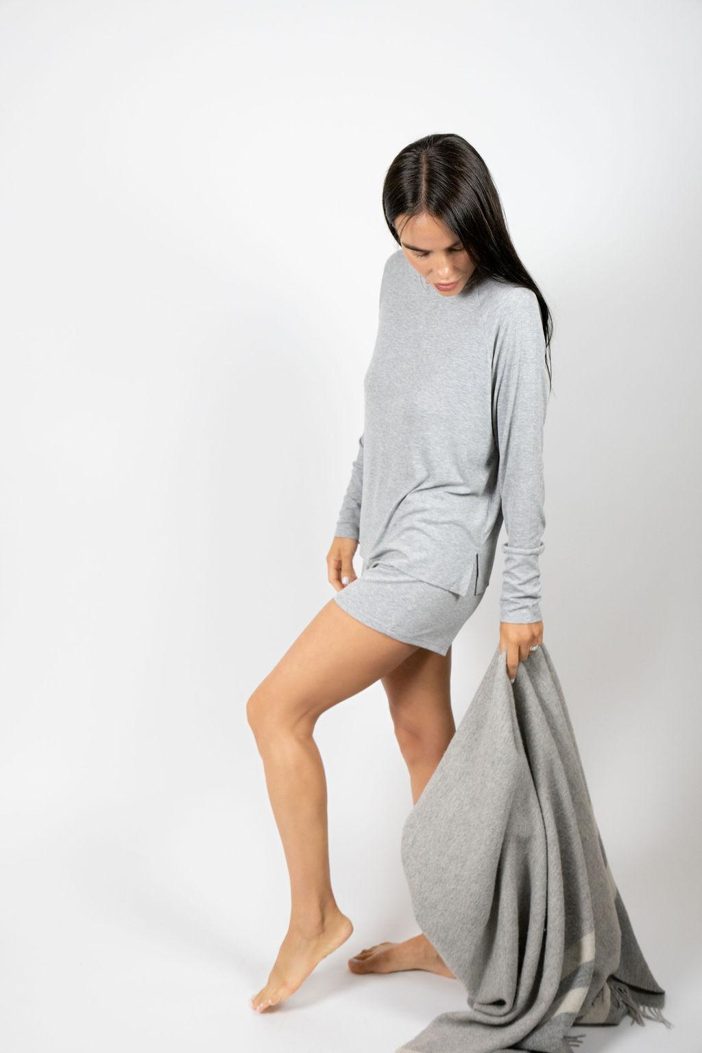 Model wearing silver ribbed long sleeve bamboo top with relaxed fit and round neckline, with matching shorts