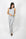 Model wearing silver ribbed lounge set with shelf-bra cami and cropped wide-leg pants