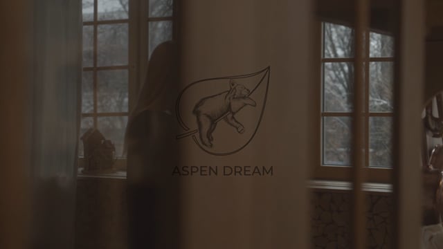 Model moves naturally through a cozy indoor setting wearing the Miley Long Sleeve Top in Black, showcasing the top’s relaxed drape, soft bamboo fabric, and elegant silhouette from different angles and matching banded joggers