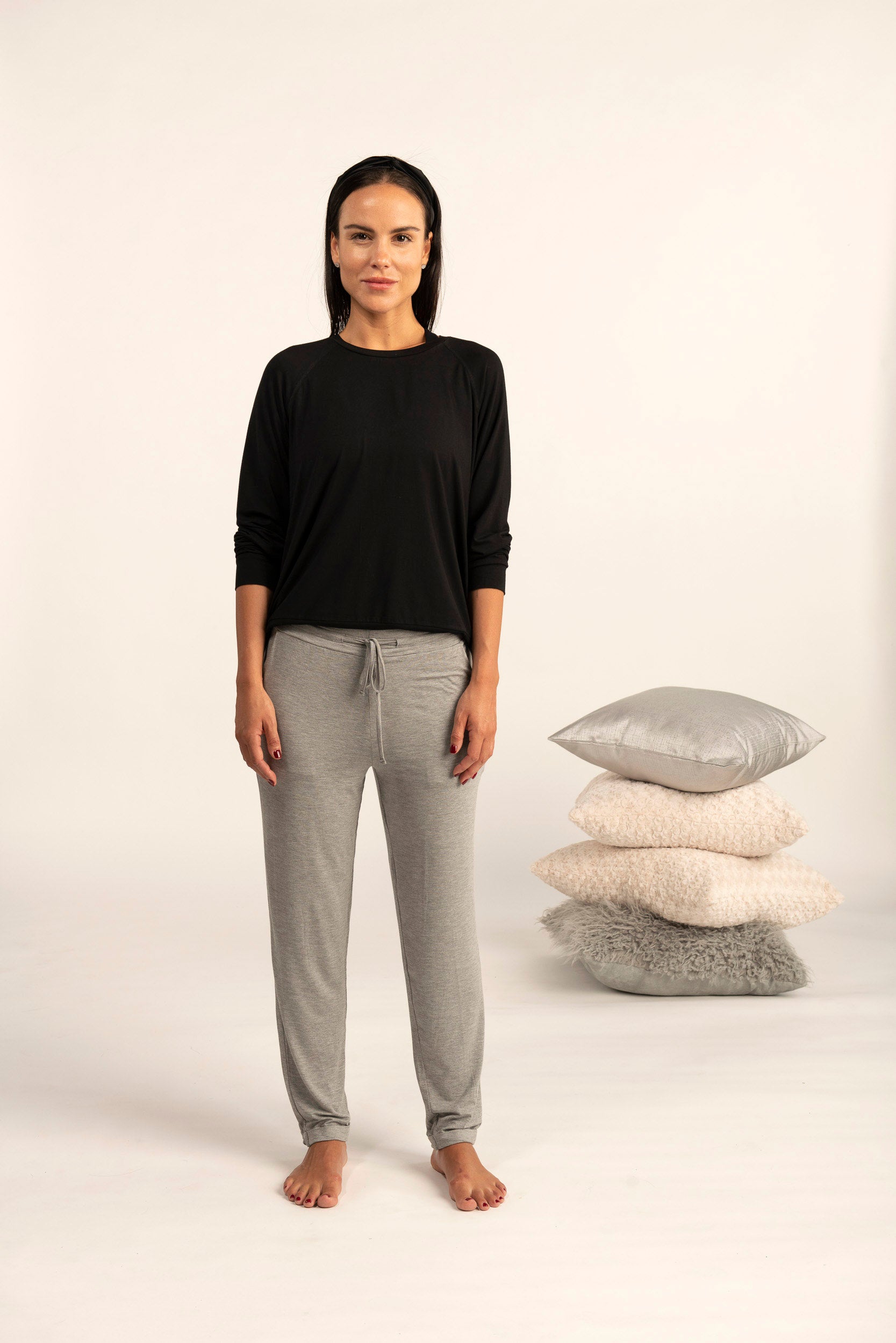 Model wearing Miley long sleeve top in black with relaxed fit and crew neckline