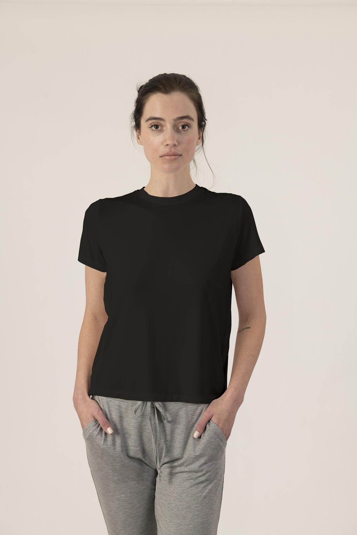 Model wearing black bamboo T-shirt with side seam detail and relaxed fit