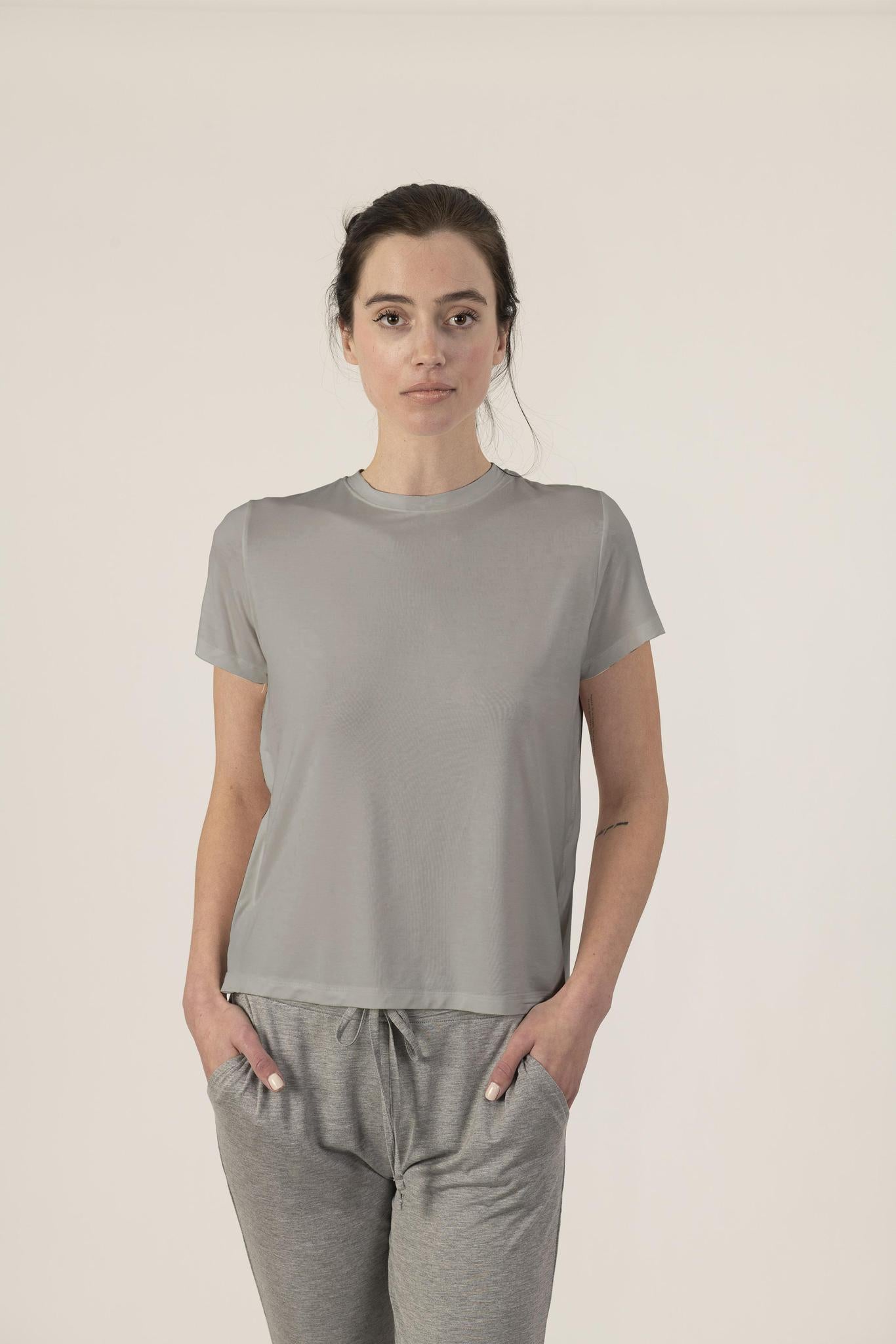 Model wearing gray bamboo T-shirt with side seam detailing and relaxed fit, with matching joggers