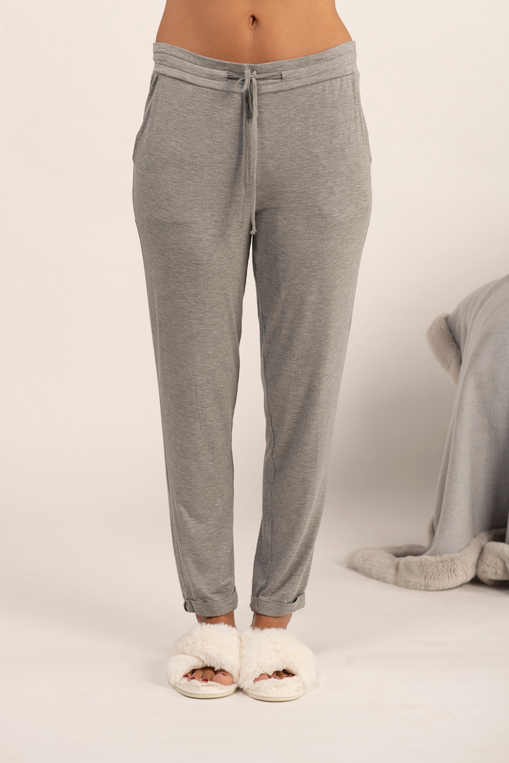 A model wearing heather gray lounge joggers with drawstring waist and pockets.