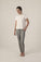 A model wearing heather gray lounge joggers with a white t-shirt, the joggers have a drawstring waist and pockets.