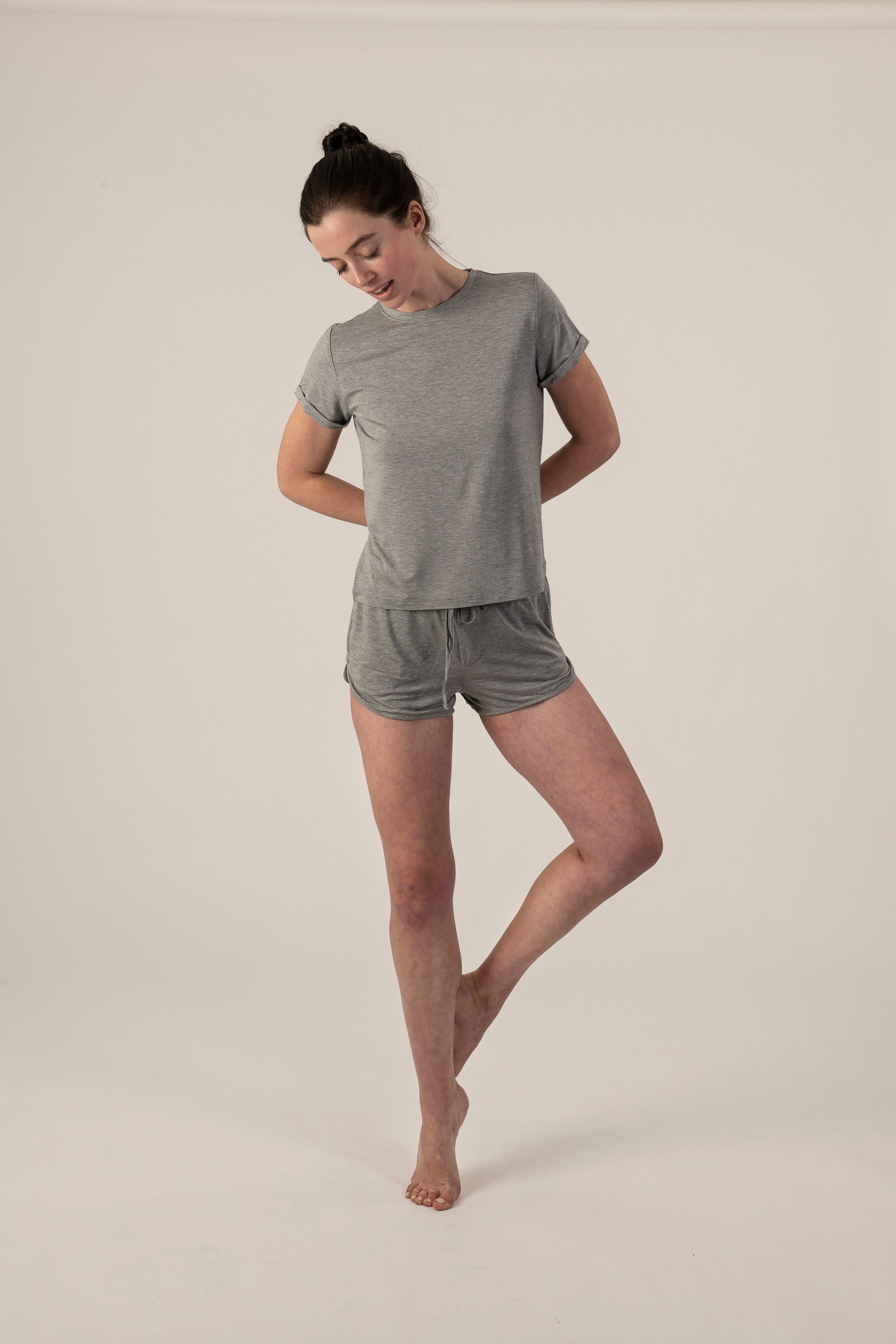 Model wearing the Taylor Rolled Sleeve T-Shirt in Gray, shown from the front to highlight the relaxed fit and rolled sleeves, with matching shorts