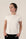 Model wearing ivory rolled sleeve T-shirt with relaxed fit and soft bamboo fabric