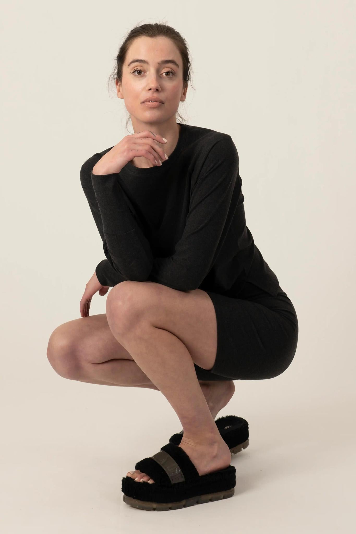Model wearing Comfy Bike Shorts in Graphite with mid-thigh length and soft stretch fit, with matching loose top.