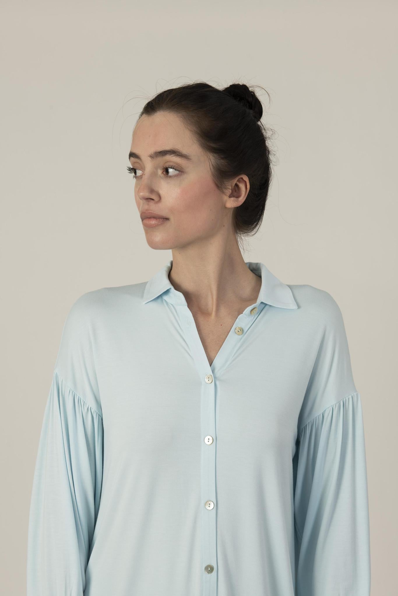 Model wearing the Dahlia Chic Nightshirt in Ice Blue with gathered neckline and button-down front