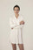 Model wearing Dahlia Chic Nightshirt in ivory with gathered neckline, long cuffs, and mother-of-pearl buttons
