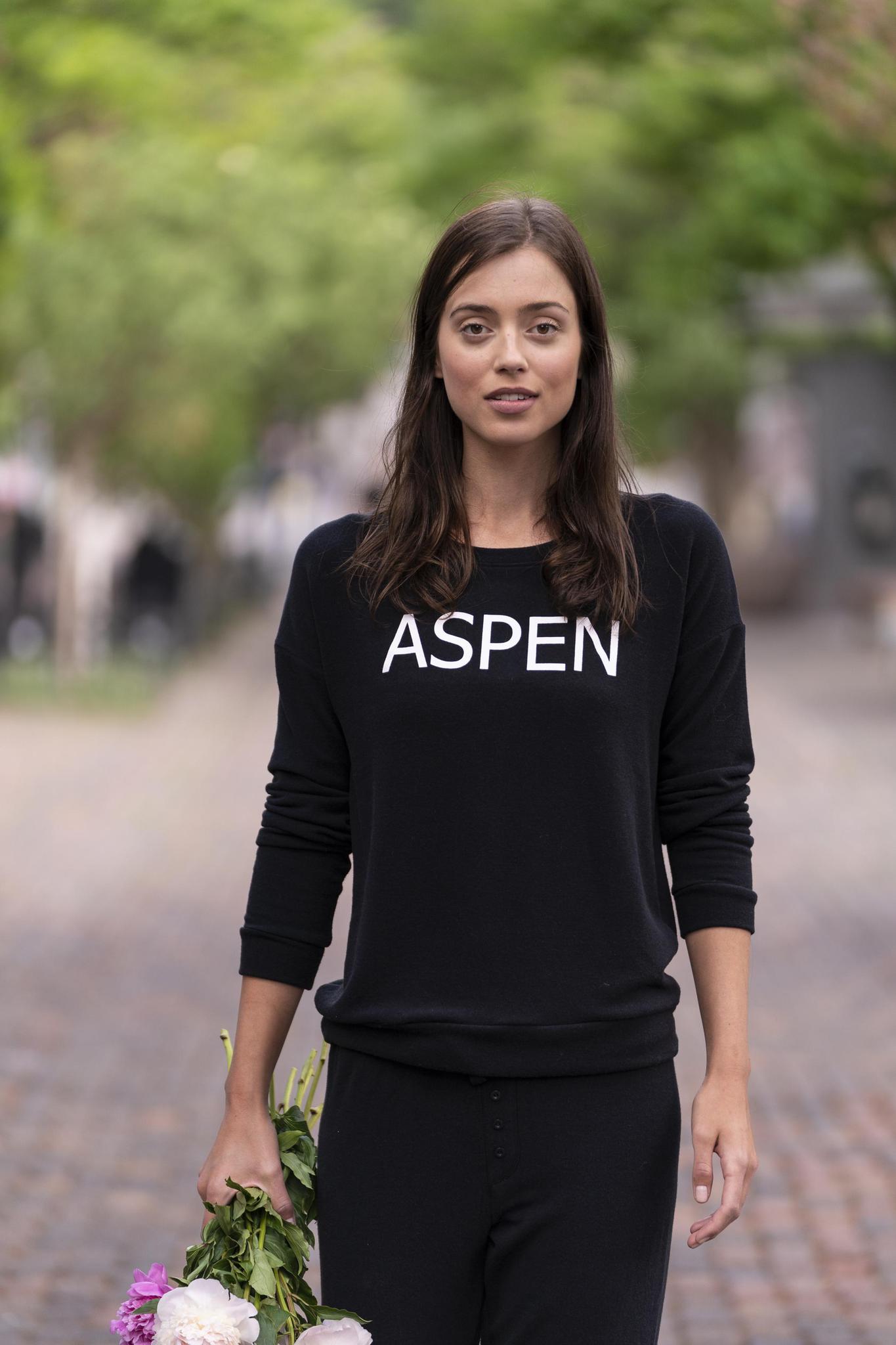 Model wearing black Hello from Aspen long sleeve top with relaxed fit and crew neckline