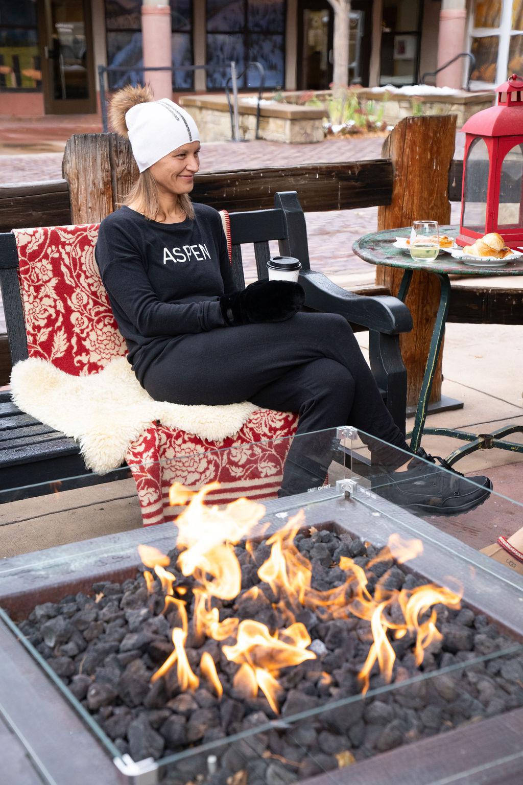 Model wearing black Hello from Aspen long sleeve top with relaxed fit and crew neckline