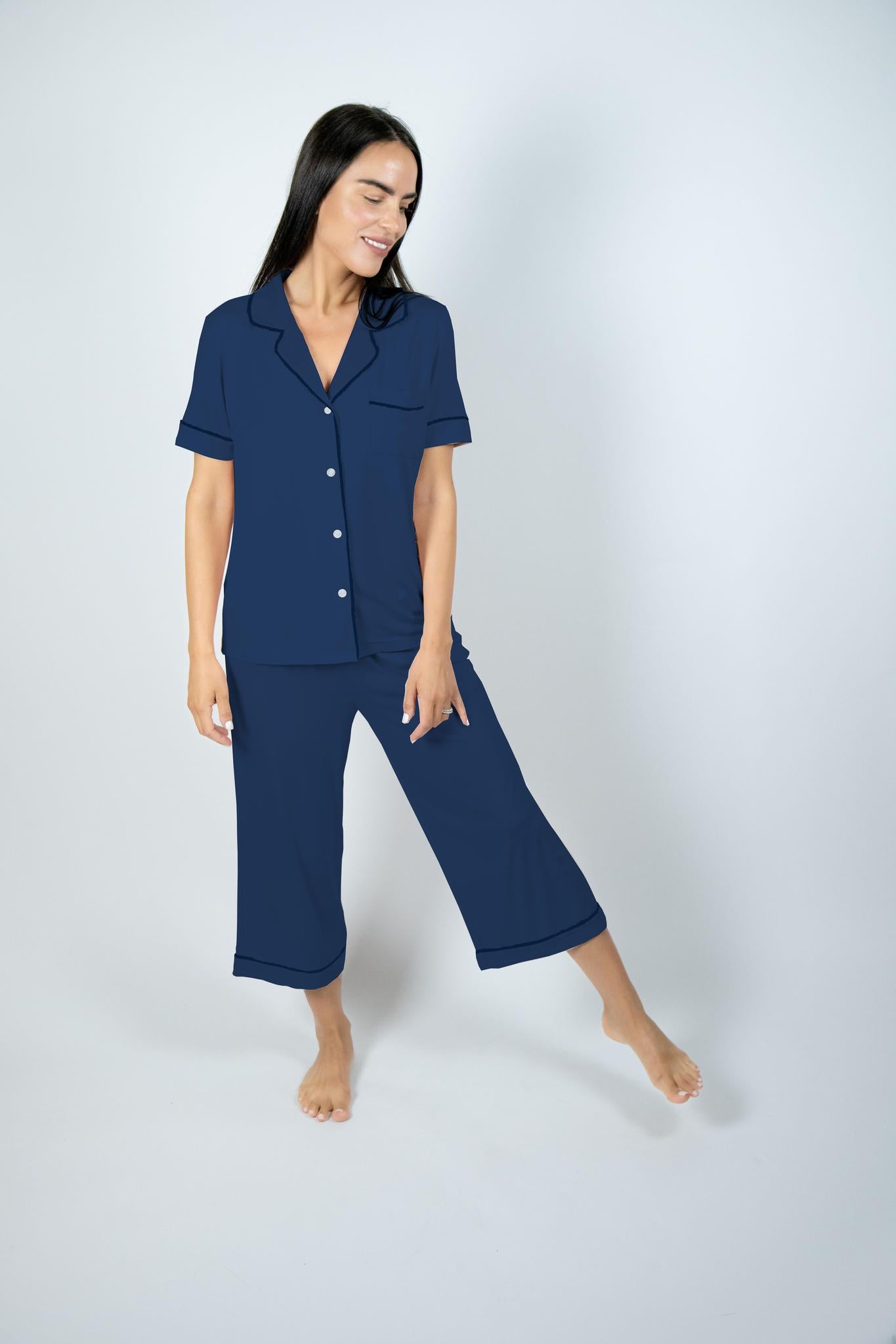 Model wearing Jolene Cropped Pajama Set in navy with ivory buttons, short-sleeve top, and mid-rise cropped pants