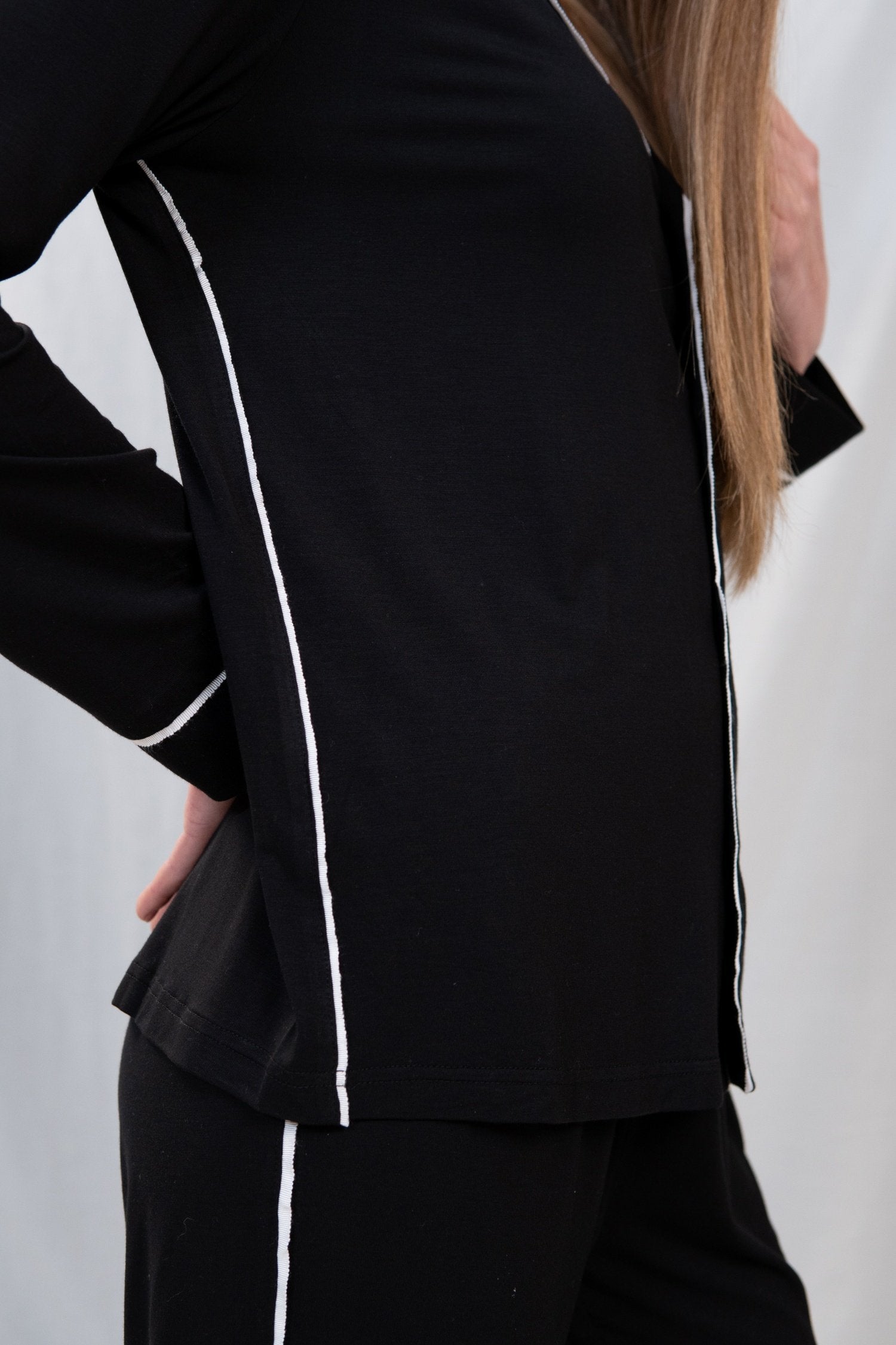 Close-up of white Japanese piping on the black Jolene pajama top