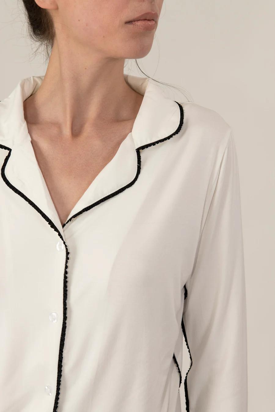 Close-up of black Japanese piping detail on the ivory Jolene pajama top