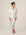 Model wearing Jolene Long Pajama Set in ivory with black piping and ankle-length tapered pants