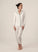 Model wearing Jolene Long Pajama Set in ivory with black piping and ankle-length tapered pants