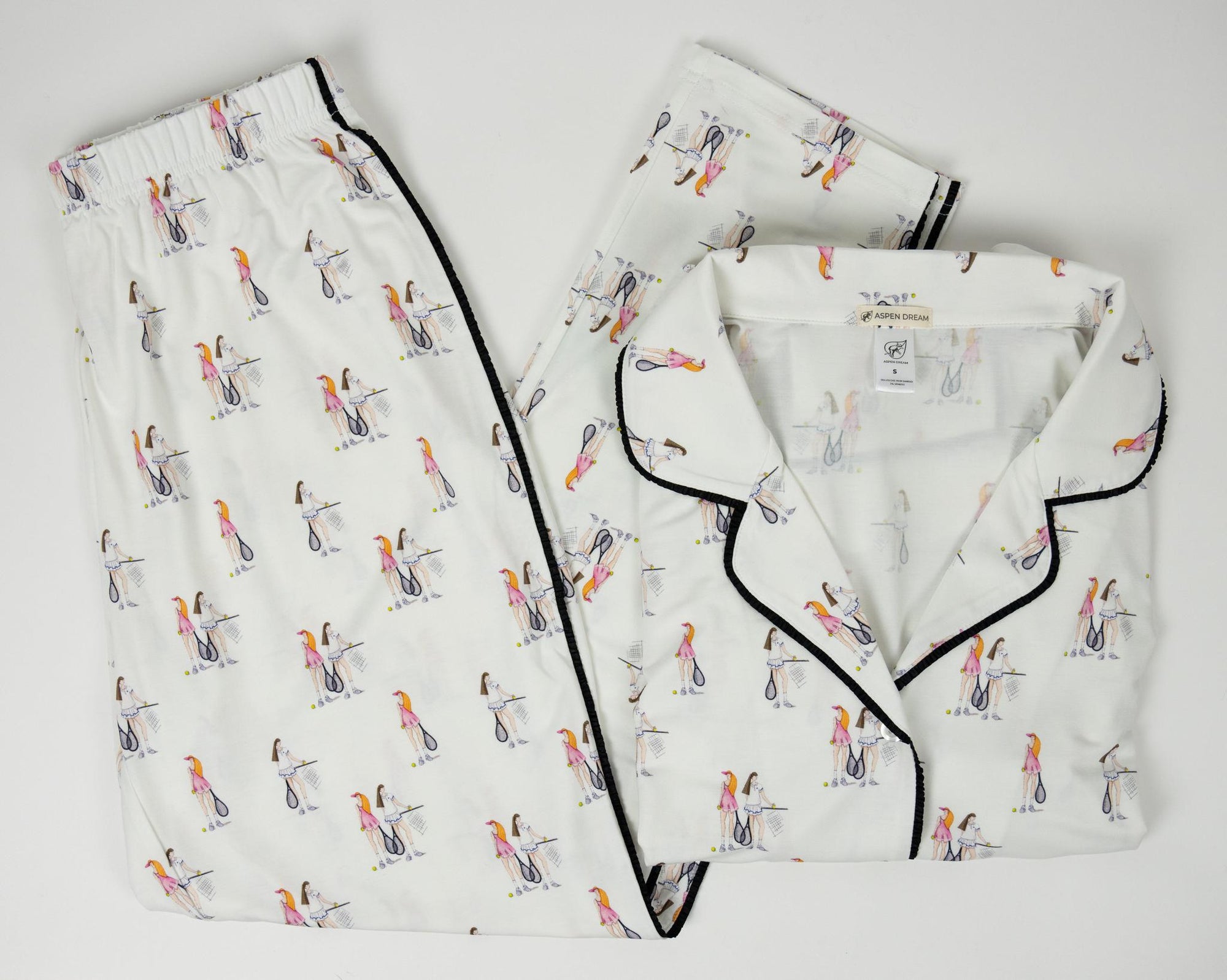 Flat lay of the Jolene Long Pajama Set in tennis print with piped button-down top and cropped pants