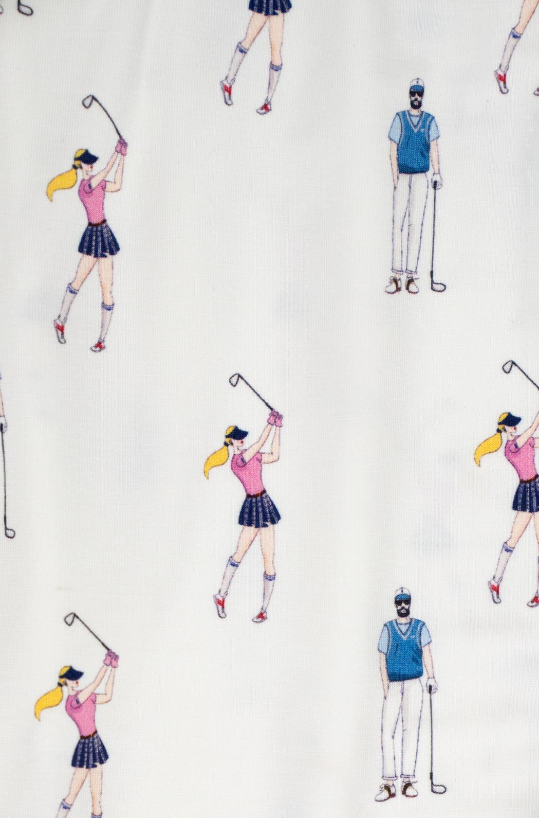 Close-up of soft pink and navy golf illustrations on ivory bamboo fabric with black piping