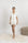 Model wearing the Jolene Short Pajama Set in ivory with black ruffled piping and notch collar