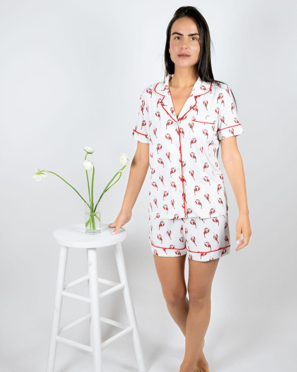 Model wearing Jolene Short Pajama Set with lobster print and red piping, featuring a button-down top and mid-rise shorts.